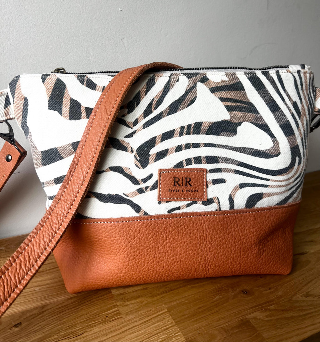 Handcrafted leather and denim cross body bag