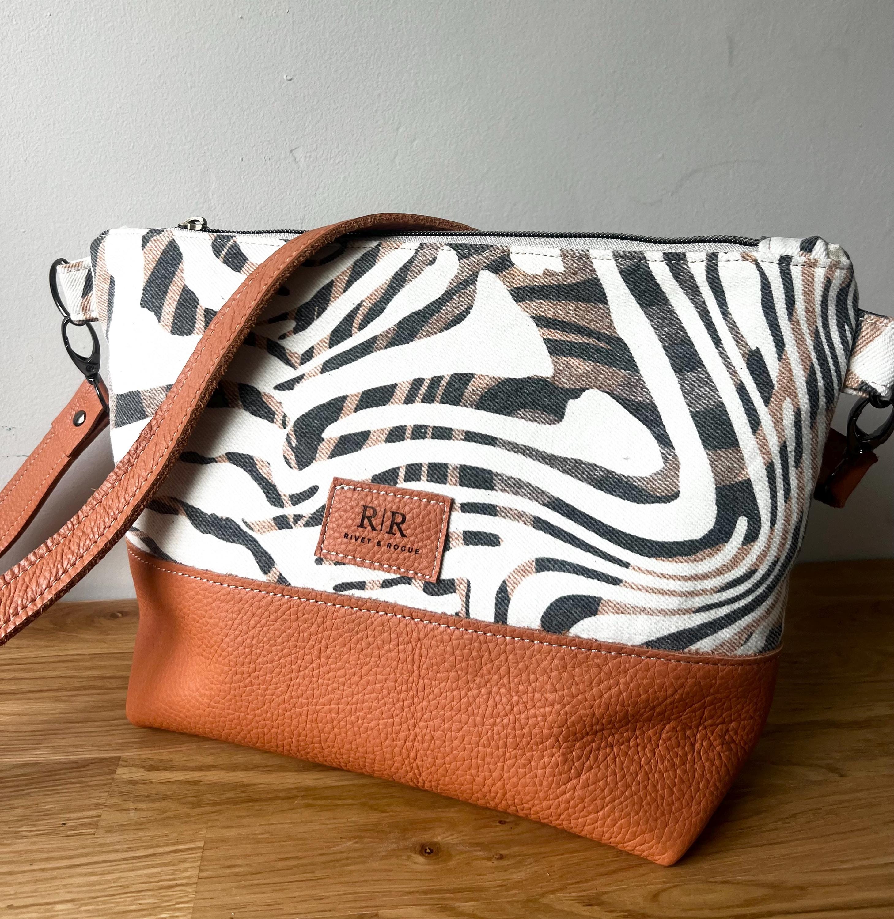 Handcrafted leather and denim cross body bag
